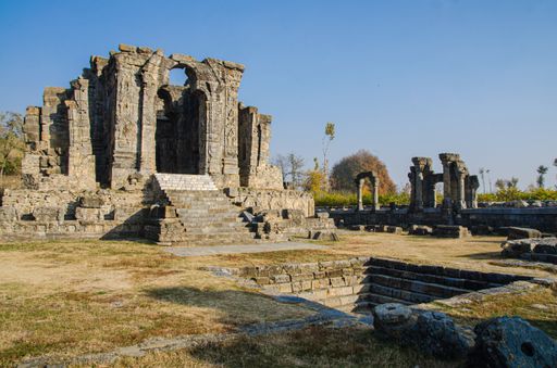 The ruins of the Martand Sun Temple under the sunlight and a blue sky in India
