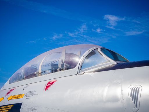 A closeup shot of an aircraft cockpit with a blue sky in the background