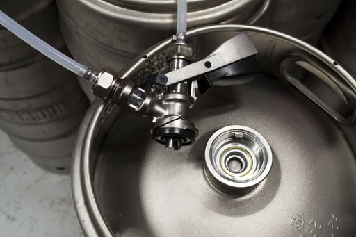 A top view of a keg with a detached coupler and pipes