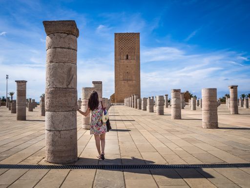 A female tourist enjoying the beautiful view of Tour Hassan in Rabat, Morocco