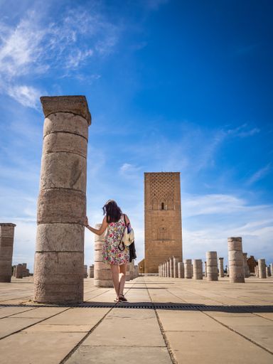 A female tourist enjoying the beautiful view of Tour Hassan in Rabat, Morocco