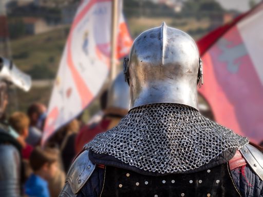 The back view of a medieval knight on a recreation event
