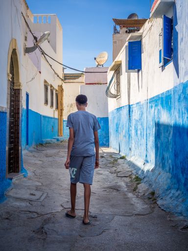 a kid walking in a street of the town of Rabat in Morocco