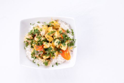 Thai coconut and mango curry with diced chicken and sliced carrots over coconut rice
