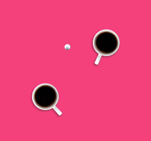 A flat lay of two coffee cups and a tennis ball on pink background
