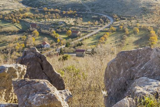 A high angle shot of a small village with in Croatia as seen through boulders