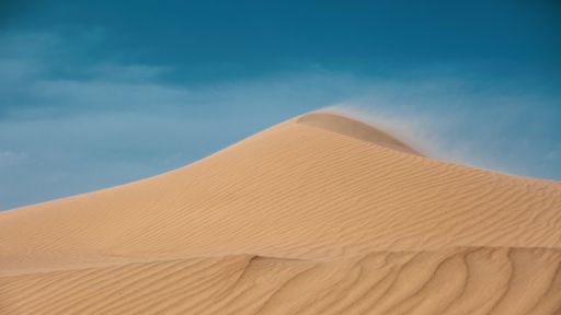 A sandy hill under the sky in a desert