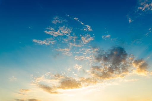 A beautiful blue sky with white clouds hanging