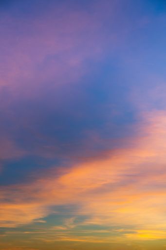 A cool vertical shot of a sky scene with colorful clouds
