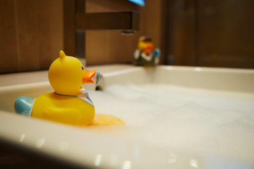 A yellow rubber duck family male and female in the bathroom