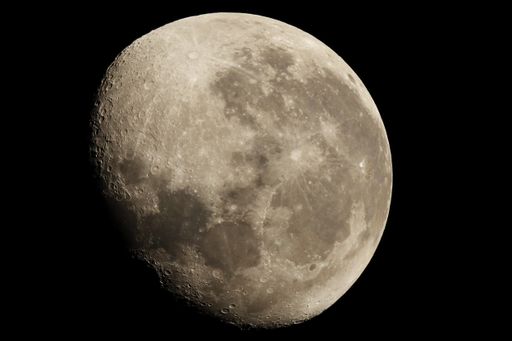 A closeup shot of the moon in a waxing gibbous phase