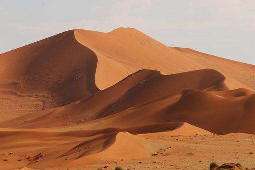 A panoramic shot of beautiful sand dunes with low and high peaks in Namib desert