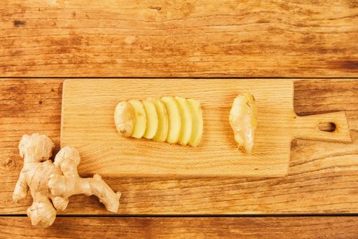 A top view of sliced ginger on a chopping board