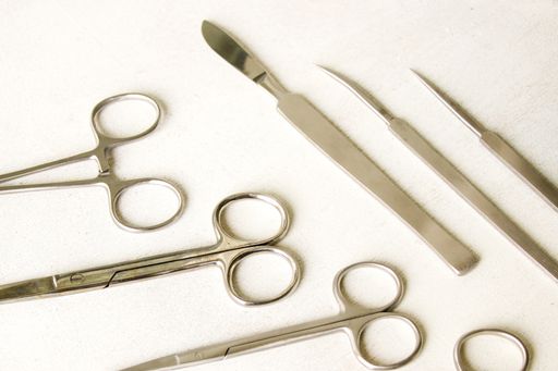 A top view of stainless steel dissecting kits on white background