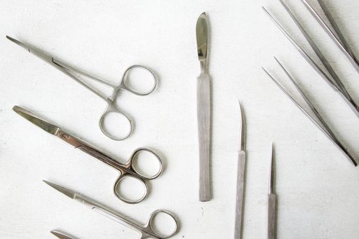 A top view of stainless steel dissecting kits on white background