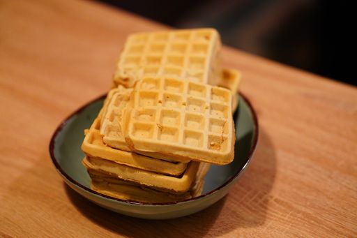 A selective focus shot of fresh homemade waffles on a plate
