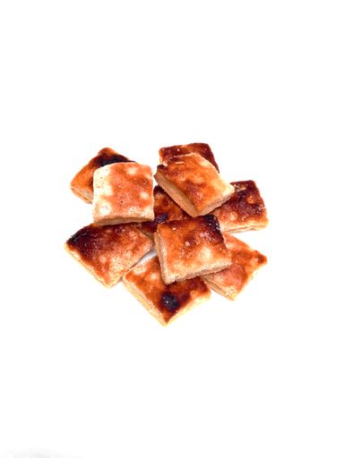 overhead shot of puff pastry cookies with melted sugar on white background. Argentine classical bakery.