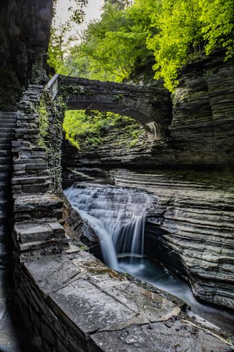 A waterfall cascading down over rocks in forest setting