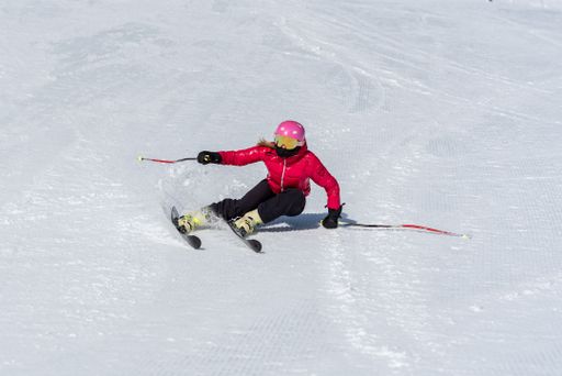 A woman skiing on a sunny winter d