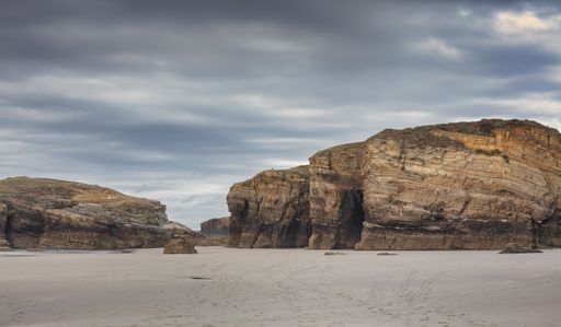 A beautiful rainy cloudscape over rugged cliffs in As Catedrais beach in Lugo, Spain