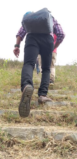 Peoples are walking over inclined walkway over hill area