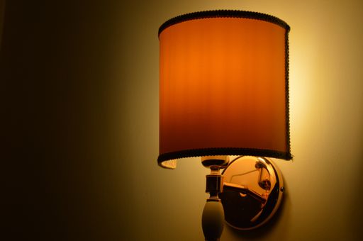 A closeup shot of a vintage illuminated lamp attached on a wall