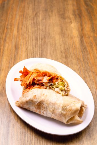 A vertical shot of traditional Mexican street food isolated on the wooden background