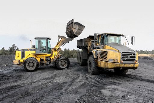 An excavator and truck for digging, loading and mining Manganese