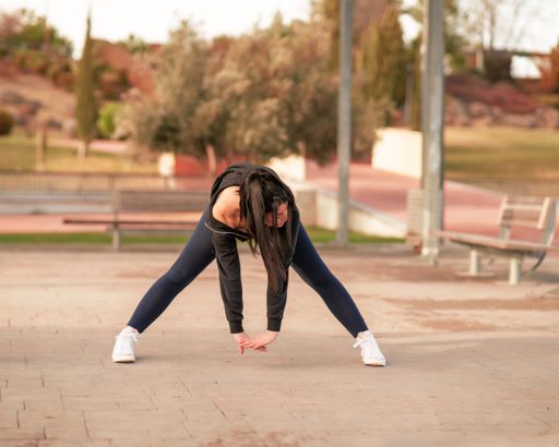 A shallow focus shot of a young Caucasian female during her workout in the park