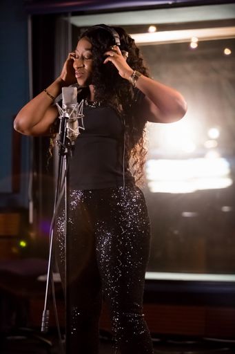 Johannesburg, South Africa - April 29, 2015: Victoria Kimani, Kenya singer recording vocal part on Afro-pop song in studio