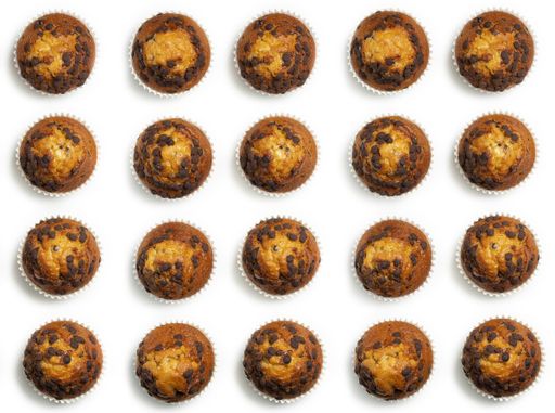 A top view of delicious cupcakes with chocolate chips, on a white surface