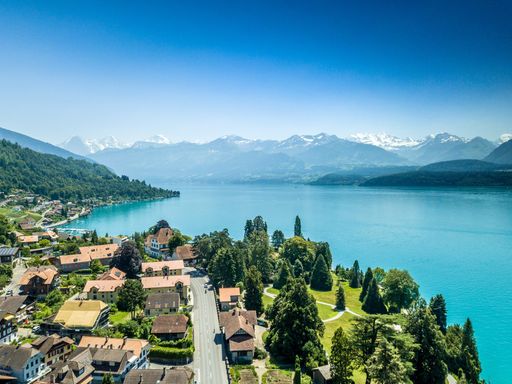 An aerial view of a small coastal town in Switzerland surrounded by mountains