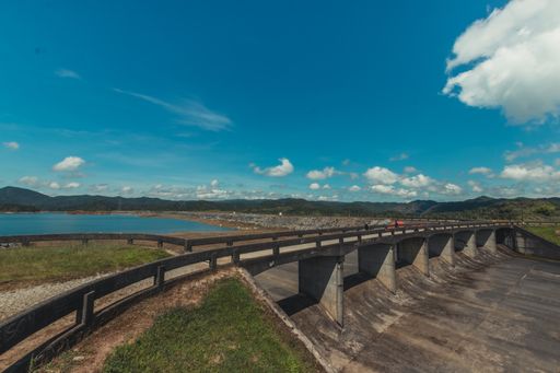 A stone-made bridge in an industrial area under a beautiful cloudscape