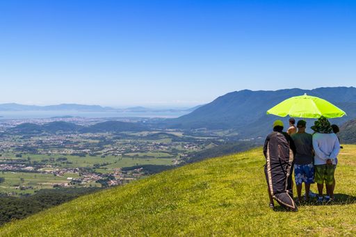 The hikers standing under an umbrella in the Hang gliding area, Brazil