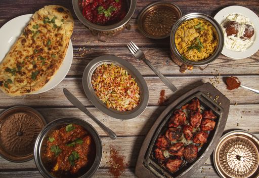 A top view of deliciously prepared assorted Indian dishes of rice and curry