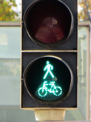 A closeup shot of a traffic light with the green bicycle on