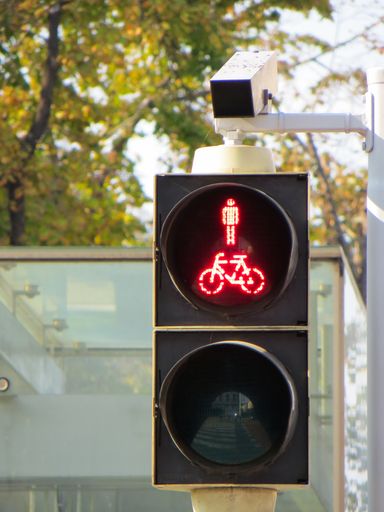A vertical shot of a traffic light showing a red graphic of a person on a bicycle