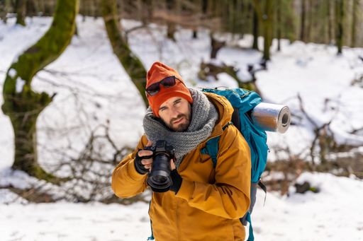 A hiker man on a trekking on the snow, winter adventures, natural activity