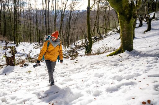 A hiker man on a trekking on the snow, winter adventures, natural activity
