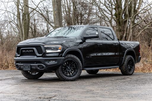 A Black 2019 Ram Rebel 1500 pickup truck on a dirt road