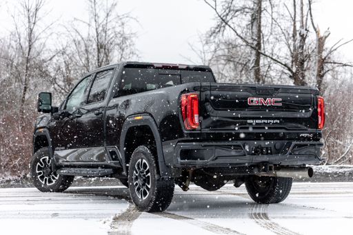 A rear view of a black 2020 GMC Sierra pickup truck in the snow