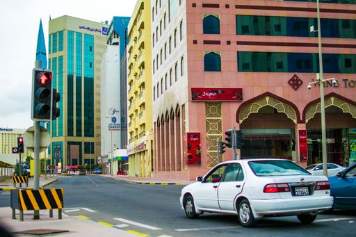 A street view of the Buildings, landmarks and public transportation system (Buses and taxies) of the city of Manama, Bahrain.