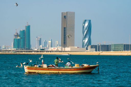 The two fishermen on a boat near the Coastal area of Muhraq, Manama, Bahrain