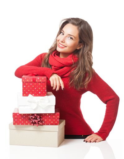 Beautiful young brunette woman with decorative Christmas gift boxes.