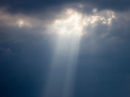 A beautiful sky with the sunlight coming out of the clouds