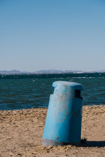 A vertical shot of a rusty metal trash can in Mar Menor, Cartagena, San Javier, Murcia, Spain