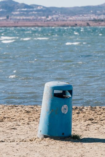A vertical shot of a rusty metal trash can in Mar Menor, Cartagena, San Javier, Murcia, Spain