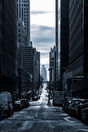 A vertical shot of a road in the middle of city buildings in New York
