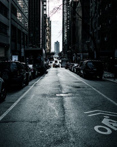 A vertical shot of a busy street in the middle of buildings in New York