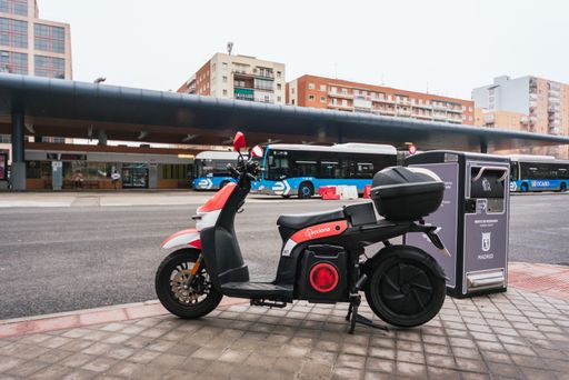 Electric scooter parked in the street. Acciona is a Spanish company for rental systems.